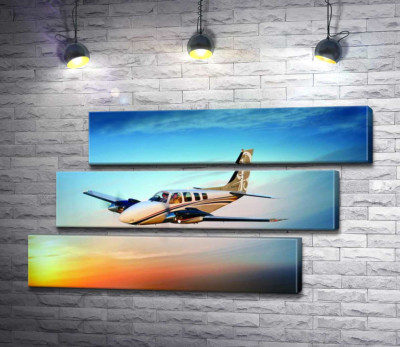 Модульна картина "Американський літак Beechcraft Bonanza серед палаючого заходу"