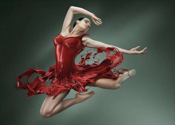 Нежная балерина грациозно летит в сочно-красном платье