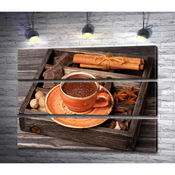 Доповнення до гарячого шоколаду в дерев'яному ящику: кориця, бодян, шоколад та мускатний горіх