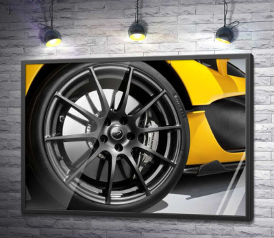 Постер "Чорний диск виблискує на колесі спортивного автомобіля McLaren P1"