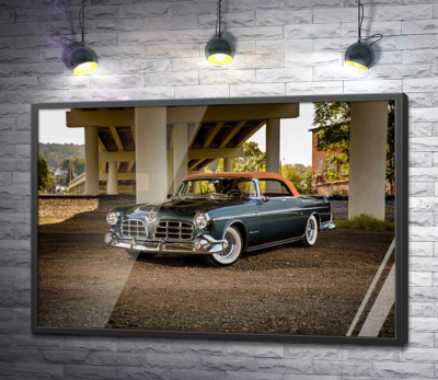 Постер "Темний автомобіль кабріолет Chrysler 1955 стоїть в тіні мосту"