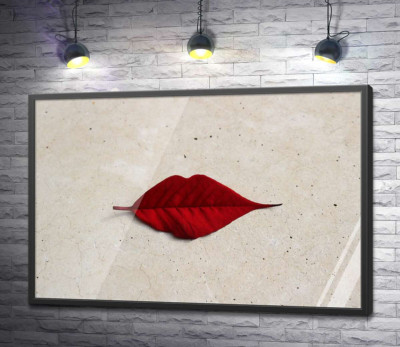Постер "Червоний листочок у формі губок лежить на мармуровій підлозі"