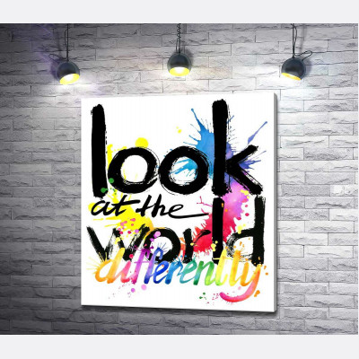 Напис "look at the world differently" на фоні кольорових плям фарби