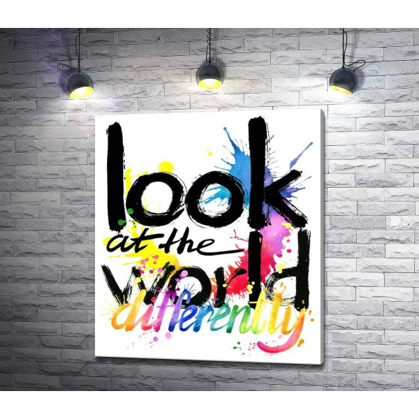 Напис "look at the world differently" на фоні кольорових плям фарби