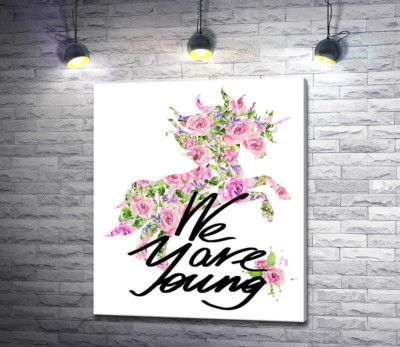 Цветочный силуэт единорога за надписью "we are young"