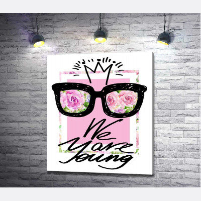 Чорні окуляри з короною над написом "we are young"