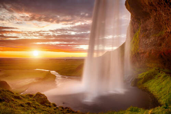 Воды водопада Сельяландсфосс (Seljalandsfoss) в лучах солнца