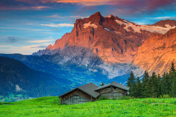 Деревянные домики на фоне утренних швейцарских гор