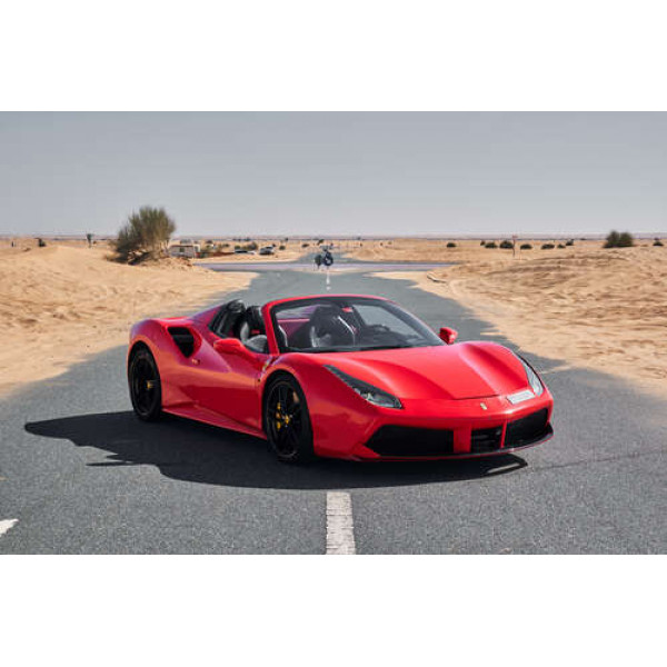 Червоний автомобіль Ferrari 488 Spider на пустельній дорозі