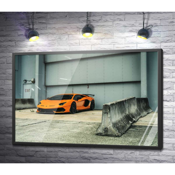 Оранжевый автомобиль Lamborghini Aventador возле ангара