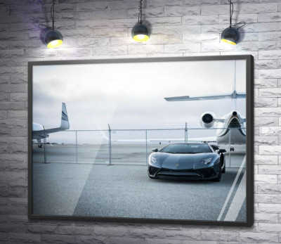 Постер "Чорний автомобіль Lamborghini Aventador на фоні літаків"