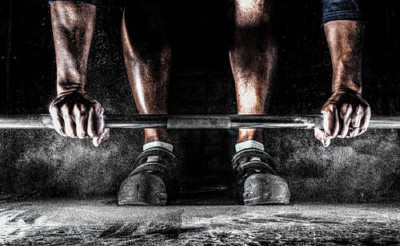 Спортсмен важкоатлет готується підняти штангу