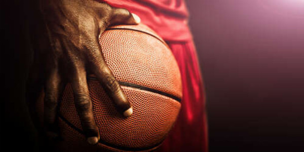 Баскетбольный мяч в большой руке спортсмена