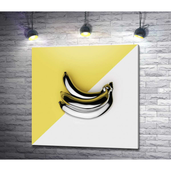 Металлические бананы на желто-белом фоне
