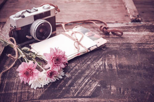 Винтажный фотоаппарат, письма и цветы на столе