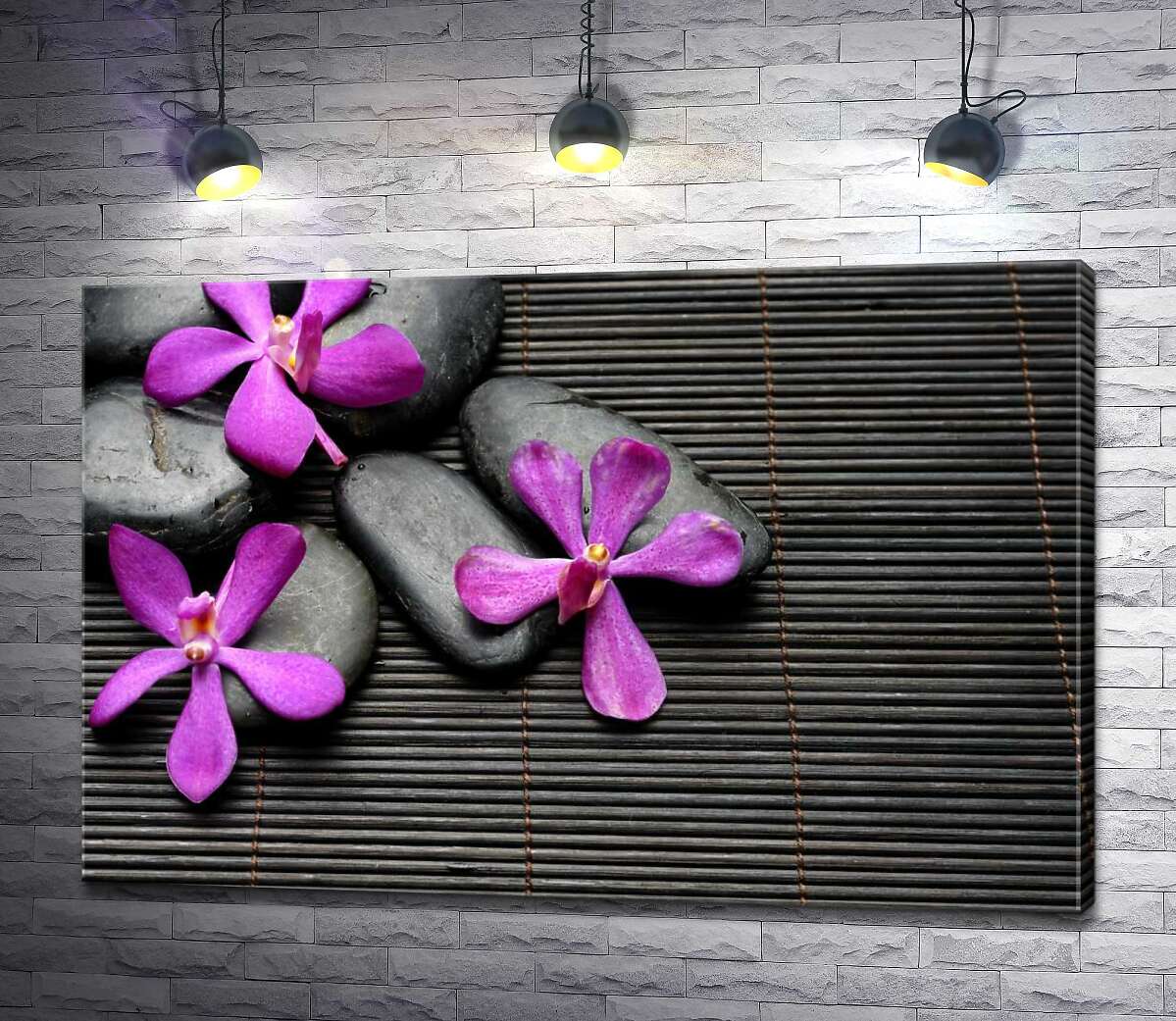 картина Яркие цветы орхидей на черных камнях и бамбуковом ковре