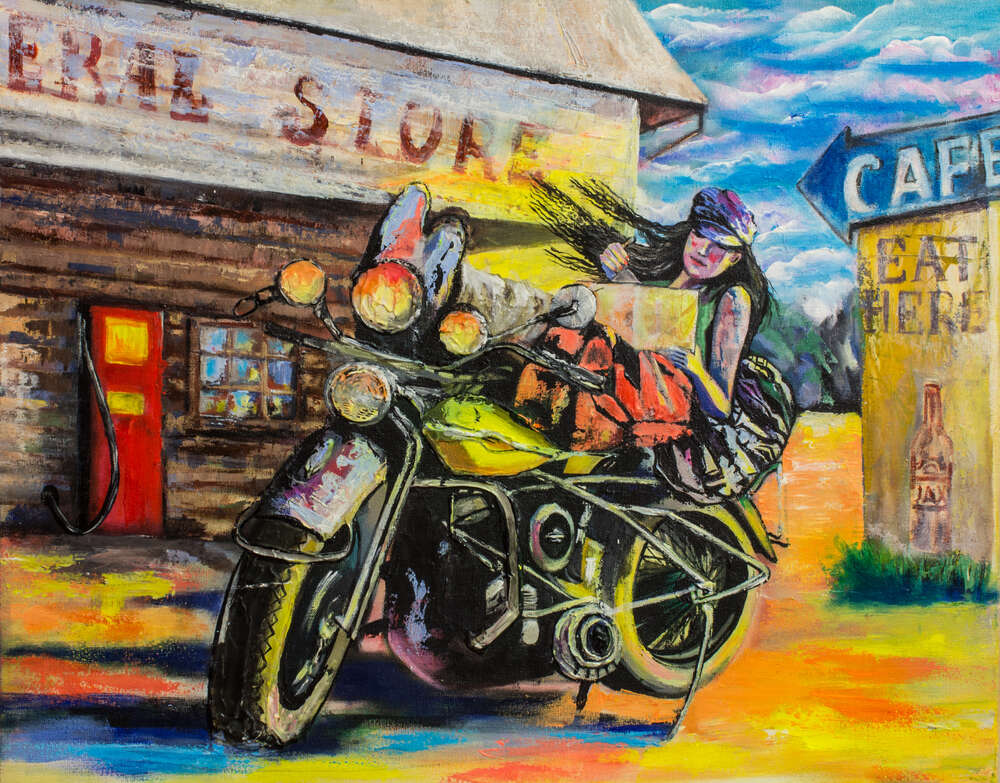 картина-постер Байкерша лежит на мотоцикле возле старой автозаправочной станции