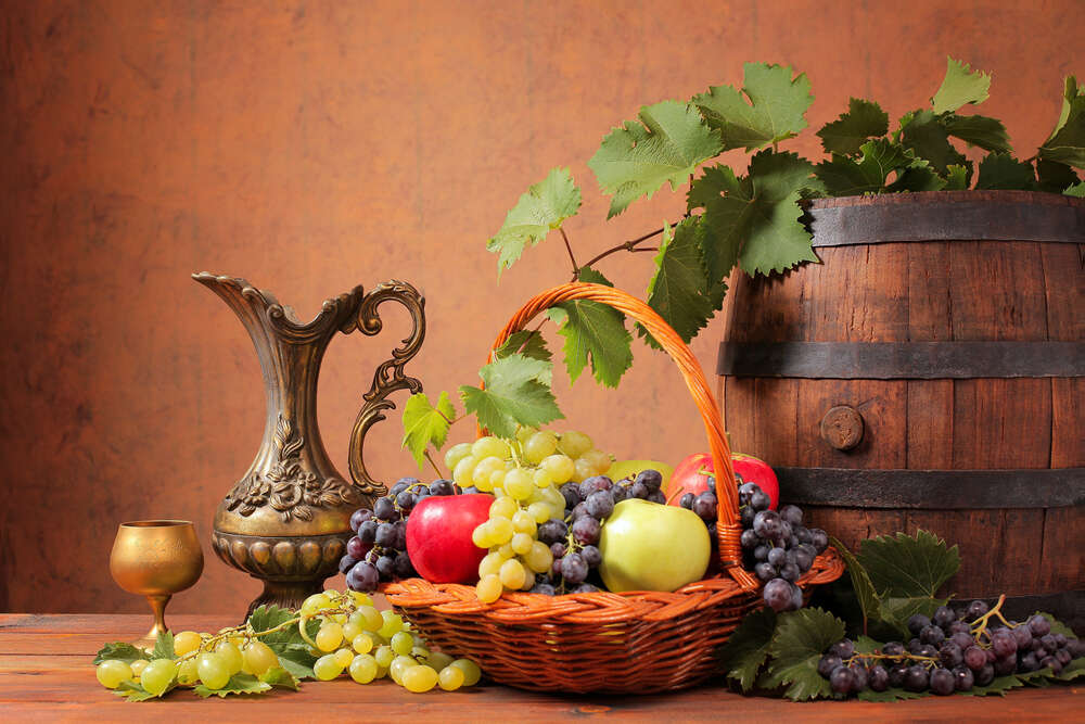 картина-постер Наполненная яблоками и виноградом корзина в окружении бочки и кувшина