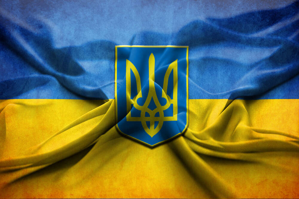 картина-постер Герб Украины на желто-голубых складках флага