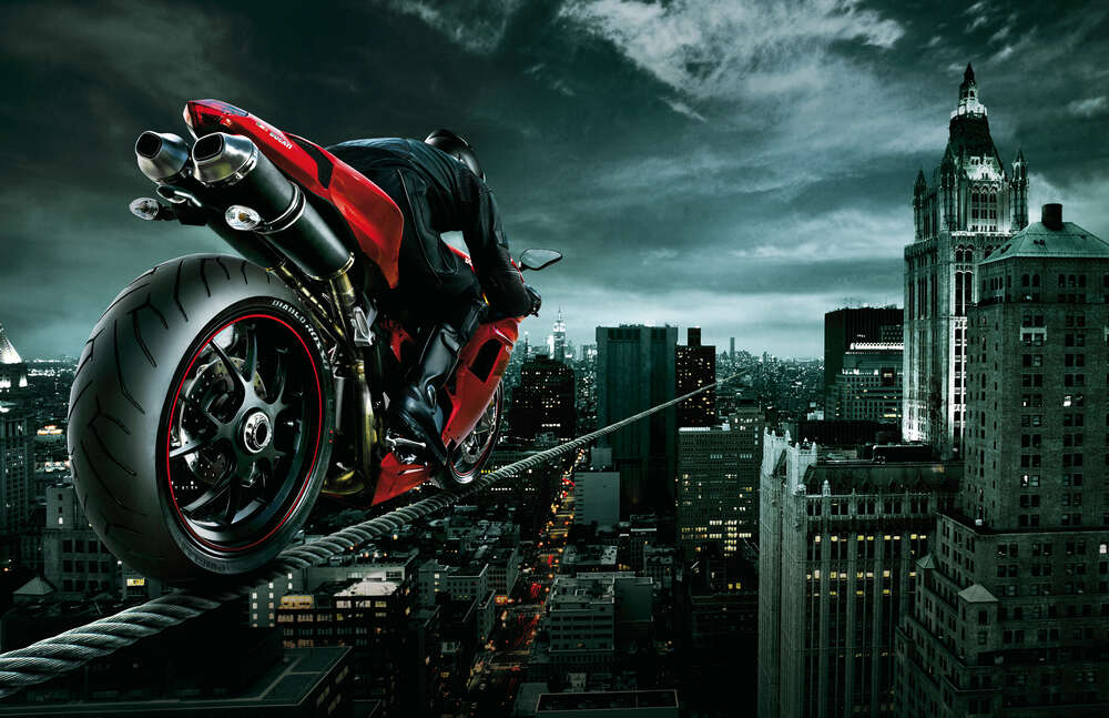 картина-постер Огненно-красный мотоцикл на канате над городом