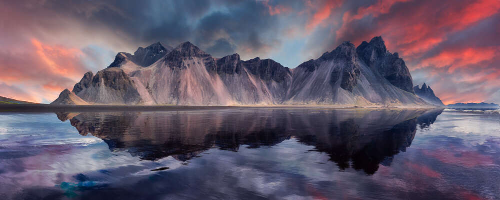 картина-постер Чарующие горы, отражающиеся в воде на фоне цветного заката